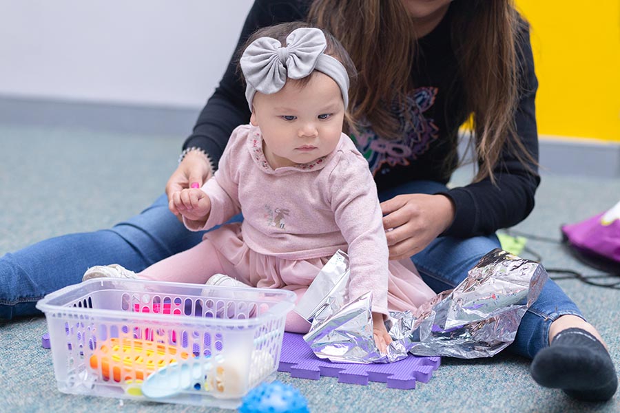 baby playing with sensory toys